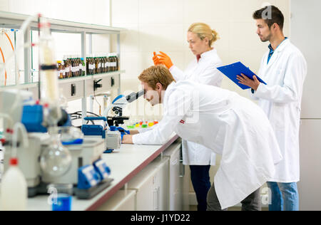 Teamwork of chemists working on analysis in lab Stock Photo
