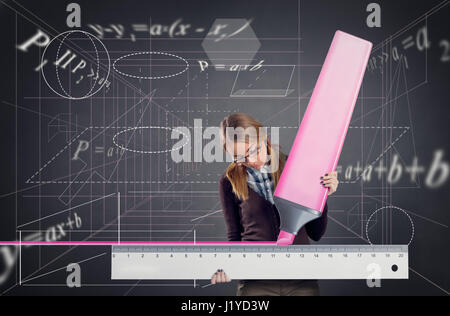 schoolgirl drawing  with a ruler and marker Stock Photo