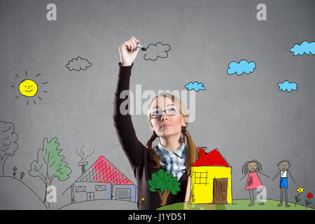 Teen girl drawing with marker  on transparent wall Stock Photo