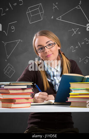 Cheerful girl siting front open books and learning Stock Photo
