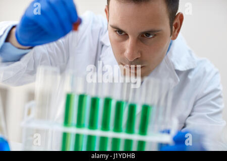 Close up scientist combining the chemical liquid using a pipette in test tube Stock Photo