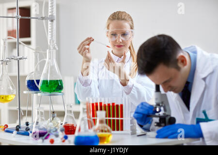 Two young science technicians at work in the laboratory Stock Photo