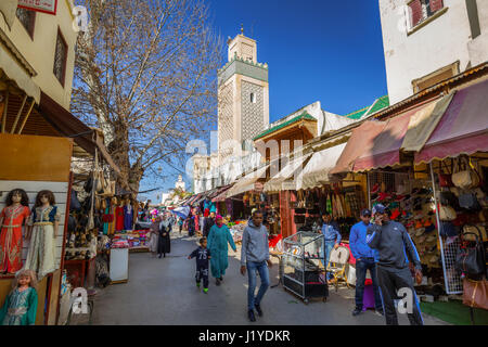 Fes, Morocco - March 01, 2017: Mosque in background of busy street of old town of Fes, Morocco Stock Photo