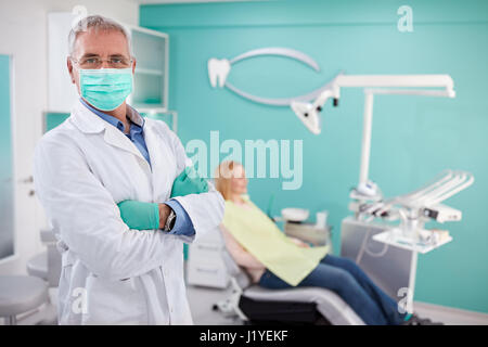 Male dentist with protecting equipment posing in dental clinic Stock Photo