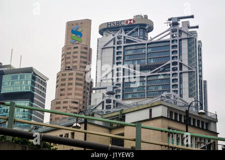Asia headquarters of Standard Chartered Bank and HSBC in Hong Kong against a grey sky Stock Photo