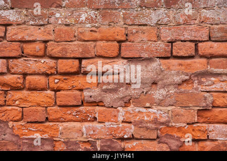 An old red brick wall in need of pointing. Stock Photo