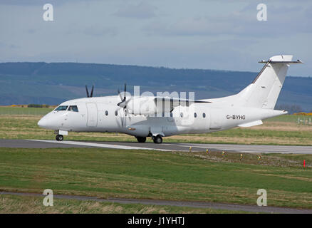 A Dornier 328-100 turboprop 33 seat passenger aircraft arriving at Inverness Dalcross Airport in the Scottish Highlands. Stock Photo