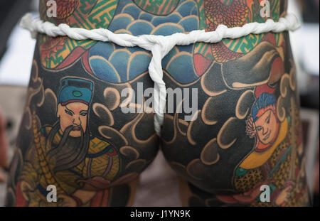 Frankfurt, Germany. 22nd Apr, 2017. A participant at the Internationalen Tattoo Convention shows their body tattooed with Asian motifs in Frankfurt am Main, Germany, 22 April 2017. Photo: Boris Roessler/dpa Credit: dpa picture alliance/Alamy Live News Stock Photo