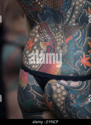 Frankfurt, Germany. 22nd Apr, 2017. A participants of the Internationalen Tattoo Convention shows her body tattooed with a horse in Frankfurt am Main, Germany, 22 April 2017. Photo: Boris Roessler/dpa Credit: dpa picture alliance/Alamy Live News Stock Photo