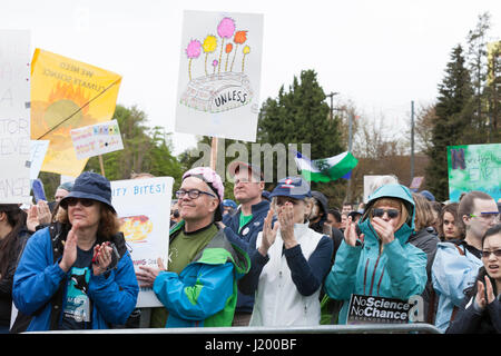 Seattle, Washington,USA. 22nd April, 2017. Protestors raise their fists during the national anthem at the rally in Cal Anderson Park. The March for Science Seattle was a non-partisan rally and sister march to the National March for Science and over 600 cities across the world on Earth Day. Thousands marched from Cal Anderson Park in the Capitol Hill neighborhood to Seattle Center to celebrate science and the role it plays in everyday lives as well as to protest the policies of the Trump administration. Stock Photo
