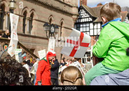 Chester, UK. 23rd April 2017. A boy with a flag watching the St George's day medieval street theatre performance in chester city centre. Credit: Andrew Paterson/Alamy Live News Stock Photo