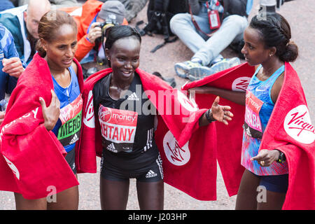 London, UK. 23rd Apr, 2017. L-R: Aselefech Mergia (ETH), 3rd, winner Mary Keitany (KEN) and 2nd placed Tirunesh Dibaba (ETH). The 37th London Marathon finishes on the Mall. Credit: Bettina Strenske/Alamy Live News Stock Photo