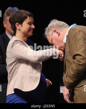 Cologne, Germany. 23rd Apr, 2017. Alexander Gauland, member of the federal management board of the AfD, kisses the hand of party chairwoman Frauke Petry on stage at the Alternative fuer Deutschland party's national convention in the Maritim Hotel in Cologne, Germany, 23 April 2017. The rightist-nationalist vice chairman of the party Alexander Gauland and the liberal Alice Weidel will lead the AfD party into the national elections. Photo: Michael Kappeler/dpa/Alamy Live News Stock Photo