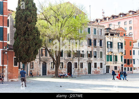 VENICE, ITALY - MARCH 30, 2017: visitors on square Campo San Polo in Venice city in spring. The Campo San Polo is the largest campo in Venice, the sec Stock Photo