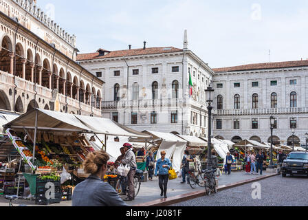 PADUA, ITALY - APRIL 1, 2017: people on outdoor market near Palazzo della Ragione on square Piazza delle Erbe in Padua city. The building of the palac Stock Photo