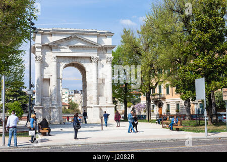 VERONA, ITALY - APRIL 2, 2017 - people near Arco dei Gavi in Verona city in spring. Arch was built in the second half of the first century, in 1930 th Stock Photo