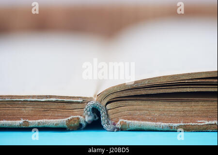 Old worn book in a canvas cover. The symbol of knowledge and learning. Close Stock Photo