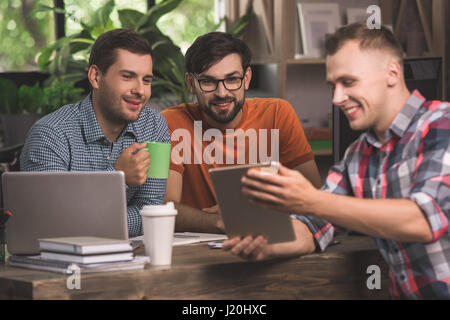 Young men programmers working together in the office  Stock Photo