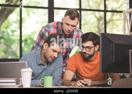 Young men programmers working together in the office  Stock Photo