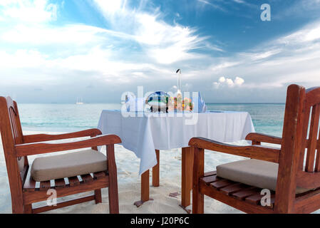 private dinner at a beach on the maldives Stock Photo