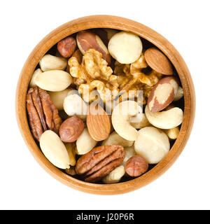 Raw mixed nuts in wooden bowl. Dried walnuts, hazelnuts, almonds, cashews, macadamia, Brazil and pecan nuts. Fancy mix of snack food. Stock Photo