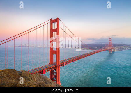 Classic panoramic view of famous Golden Gate Bridge seen from Battery Spencer viewpoint in beautiful post sunset twilight during blue hour at dusk in  Stock Photo