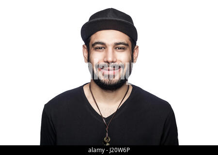 Portrait of young happy smilely man with black t-shirt and cap looking at camera with toothy smile. studio shot, isolated on white background. Stock Photo