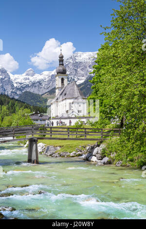 Scenic mountain landscape in the Bavarian Alps with famous Parish Church of St. Sebastian in the village of Ramsau in springtime, Bavaria, Germany Stock Photo