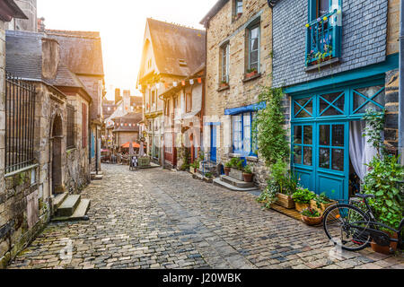 Panoramic view of a charming street scene in an old town in Europe in beautiful evening light at sunset with retro vintage toned filter effect Stock Photo