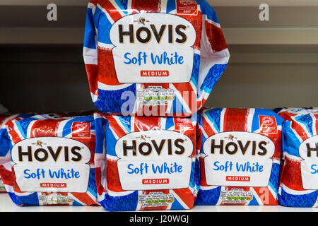 Loaves of Hovis Medium Sliced Soft White bread for sale on a supermarket shelf, in Union Jack themed wrapping. Stock Photo