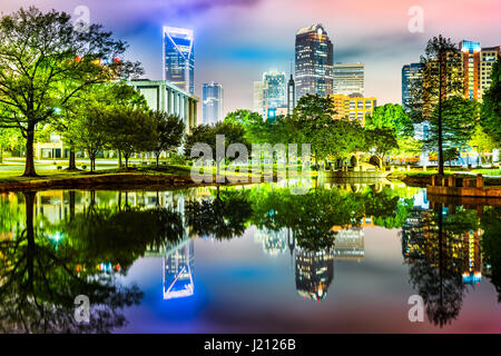 Charlotte, NC skyline reflected in Marshall Park pond on a foggy night Stock Photo