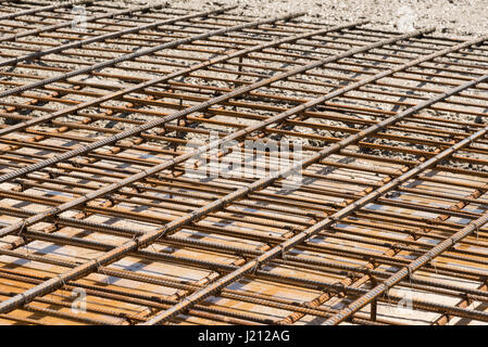 The wet concrete is poured on a steel reinforcement to form strong floor slabs. Stock Photo