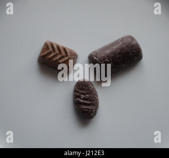 Three chocolates on white background close up Stock Photo