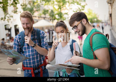 Travelling young people sightseeing and eating ice creams Stock Photo