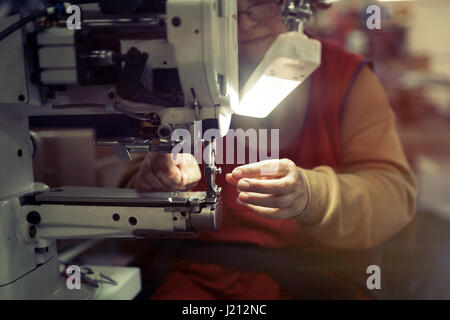 Woman working in sewing industry on machine