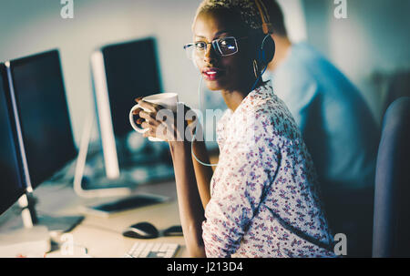 Beautiful female working at IT company as administrator Stock Photo