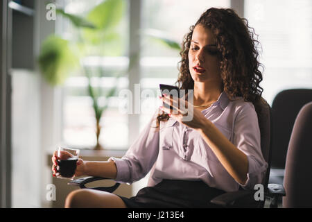 Beautiful overworked tired businesswoman working overtime in office Stock Photo