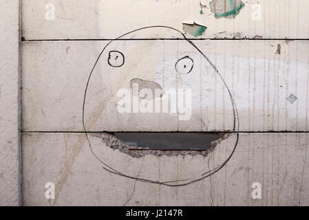 A face drawn on a broken fence Stock Photo