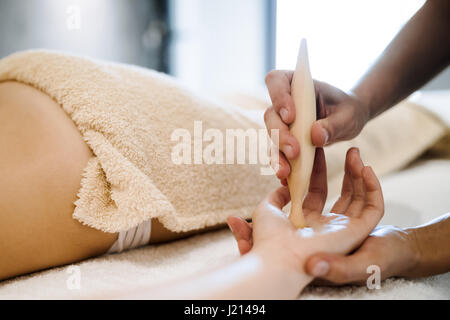 Hand and palm massage by therapist at spa resort Stock Photo