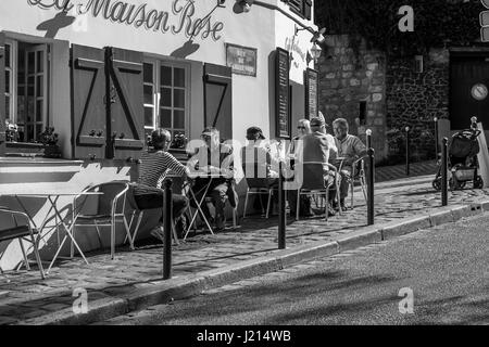 Parisians and tourists enjoy lunch at a sidewalk cafe in Paris, France Stock Photo