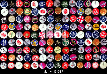 SOUTHAMPTON, UK - 21 Jan 2017: A background of bottle caps from a variety of popular beers, lagers and ciders from around the world. Stock Photo