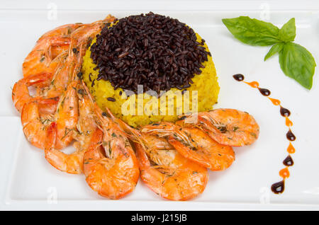 Sea gift. Shrimp with yellow rice and black. Stock Photo