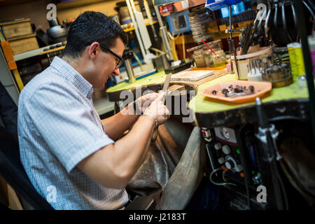 Jeweler working on workbench with many tools Stock Photo