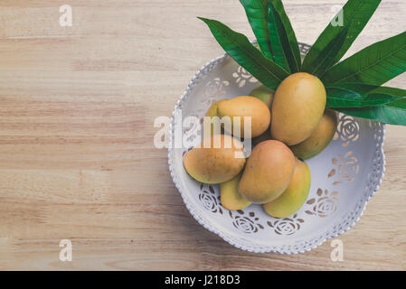 Mango on a wooden table Stock Photo