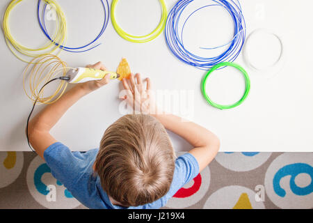 Child using 3d printing pen. Creative, technology, leisure, education concept Stock Photo