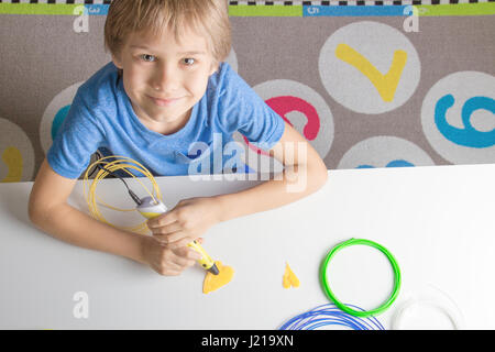 Boy using 3D printing pen. Creative, leisure, technology education concept Stock Photo