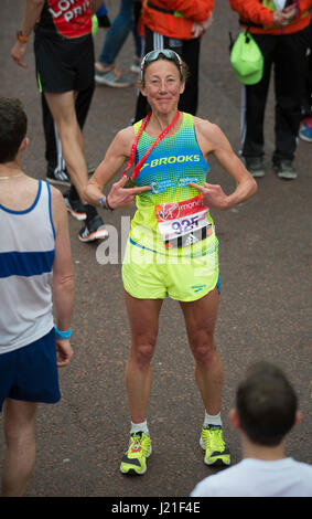 The Mall, London, UK. 23rd April, 2017. Chrissie Wellington OBE, former professional triathlete and four-time Ironman Triathlon World Champion finishes the 2017 Virgin Money London Marathon in 02:49:01. Credit: Malcolm Park/Alamy Live News. Stock Photo