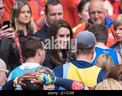 London, UK. 23rd April, 2017.HRH Catherine Duchess of Cambridge, hands out medals at the finish at the Virgin Money Marathon Credit: Ian Davidson/Alamy Live News Stock Photo