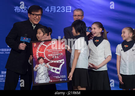 Budapest, Hungary. 23rd Apr, 2017. Movie star Jackie Chan (1st L) and students from the Hungarian-Chinese Bilingual Primary and Secondary School attend the opening ceremony of the 2017 Chinese Film Festival at the Urania National Film Theater in Budapest, Hungary, on April 23, 2017. The 2017 Chinese Film Festival started here on Sunday with the presence of world famous film star Jackie Chan and five movies, one of which is Jackie Chan's latest production 'Kung Fu Yoga'. Credit: Attila Volgyi/Xinhua/Alamy Live News Stock Photo