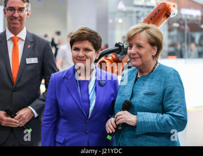Hanover, Germany. 24th Apr, 2017. German Chancellor Angela Merkel (front R) and Polish Prime Minister Beata Szydlo (front L) visit the booth of Kuka during the Hanover Messe 2017 in Hanover, Germany, April 24, 2017. The Hanover Messe 2017, with the lead theme 'Integrated Industry -- Creating Value' and Poland as the official Partner Country, will last until April 28. Credit: Shan Yuqi/Xinhua/Alamy Live News Stock Photo
